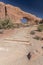 Steps up to North Window Arch and desert brush, Arches National Park Moab Utah