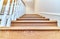 Steps of a wooden staircase with white balusters. Bottom view