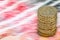 Sterling pound depreciation devaluation reduction value concept closeup macro view at UK currency stack of one pound coins
