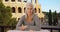 Stern Caucasian lady sitting near Colosseum stares at camera intently