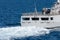 Stern of navy surface warship sails with high speed creating white bubble and wave at the stern of the ship