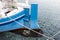 The stern of a wooden boat with a rudder and a propeller in the clear water of the Adriatic sea