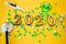 Stethoscope with 2020 number , green pills and dummy on yellow background. Happy New Year for health care and medical calendar