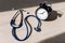 Stethoscope and alarm clock on a wooden table in the sunlight. A tool for measuring blood pressure. Desktop cardiologist