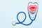 Stethoscope and beautiful rose heart on blue background. Thank You heroes Doctor and Nurses concept