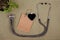 stethoscope, blank blackboard in the form of heart, shopping bag