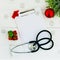 Stethoscope, blank clipboard and Christmas decorations on wooden table