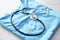 Stethoscope with blue doctor\\\'s uniform on table