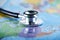 Stethoscope with blur world map at United states of america
