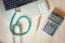 Stethoscope and Calculator on Doctor Office Table., Table Workspace Desktop for Examining Patient Health., Business Healthcare