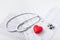 Stethoscope, cardiogram and red heart