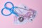 stethoscope and euro banknotes on pink background, a symbol of stability, growth and fall of currencies, monitoring the exchange