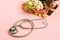 Stethoscope, gift box and eustoma flowers on pink background. Happy Doctor\\\'s Day