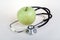 Stethoscope and green apple. Healty food