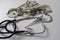 Stethoscope, handcuffs and money on gray background.