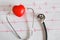 Stethoscope with  heart ball on paper heart sign wave