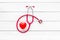 Stethoscope and heart for diagnostic and cure of heart disease on white desk background top view mockup