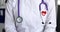 Stethoscope and heart shaped icon with electrocardiogram on doctor coat closeup 4k movie slow motion