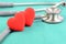 Stethoscope and hearts on green background in heart check up con