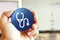 Stethoscope icon blue round button holding by hand infront of workspace background