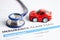 Stethoscope on Insurance claim accident car form, Car loan, insurance and leasing time concepts