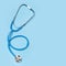 Stethoscope isolated on blue, top view. Medical tool. Medical tool. stethoscope is an important diagnostic tool, copy space.