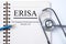 Stethoscope on notebook and pencil with ERISA The Employee Reti