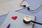 Stethoscope, notepad, pen, cardiogram heart icon