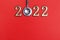 Stethoscope number 2022 on red background creative idea new trend medical banner calendar cover closeup with copy space