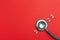 Stethoscope number 2022 on red background creative idea new trend medical banner calendar cover closeup with copy space