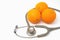 Stethoscope with orange fruit