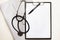 Stethoscope, pen and notepad on white background. Heart treatment concept, cardiology