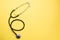 Stethoscope phonendoscope on a yellow background, copy space