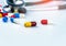 Stethoscope with pile of colorful antibiotic capsule pills on white table. Antimicrobial drug resistance and overuse. Medical