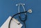 Stethoscope, prescription, on blue background. The concept of medicine.