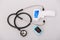 Stethoscope, pulse oximeter and thermometer gun on white background. Phonendoscope. Infrared isometric thermometer gun