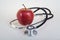 Stethoscope and red apple. Healty food