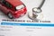 Stethoscope with red car on Insurance  claim accident car form, Car loan, insurance and leasing time concepts