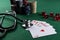 Stethoscope, red cubes and poker playing cards as a gambling with your health concept