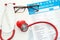 Stethoscope with red heart and lists of laboratory tests on white background.  Health care concept