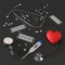 Stethoscope, red toy heart, tonometer, thermometer, pills on a dark background. 3d rendering