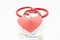 Stethoscope and red velvet heart lie on each other on white uniform background. Photo for use in cardiology, heart health, heart d