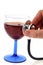 A stethoscope resting on a glass of red wine