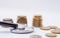 Stethoscope With Stacked Coin on white background, checkup Covid-19