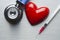 Stethoscope, syringe and figurine in the shape of a heart