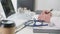 Stethoscope on a table in a physician examination room. Doctor write a prescription or records patient examine results