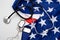 Stethoscope with tokens and stars of USA flag background