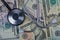 Stethoscope on top of American dollar bills