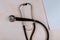 Stethoscope on work desk of doctor in hospital with medical blank notebook