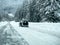 Stevens Pass, WA USA - circa December 2022: Wide view of vehicles putting on snow tire chains on the side of the road during snowy